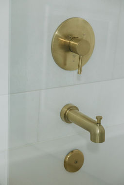 Round brushed brass shower valve detail — Beverly Hills Michigan bathroom remodel by Costello & Co Construction
