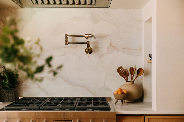 Close-up of marble backsplash and natural wood cutting boards