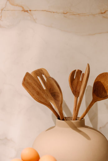 Close-up of marble backsplash and natural wood cutting boards