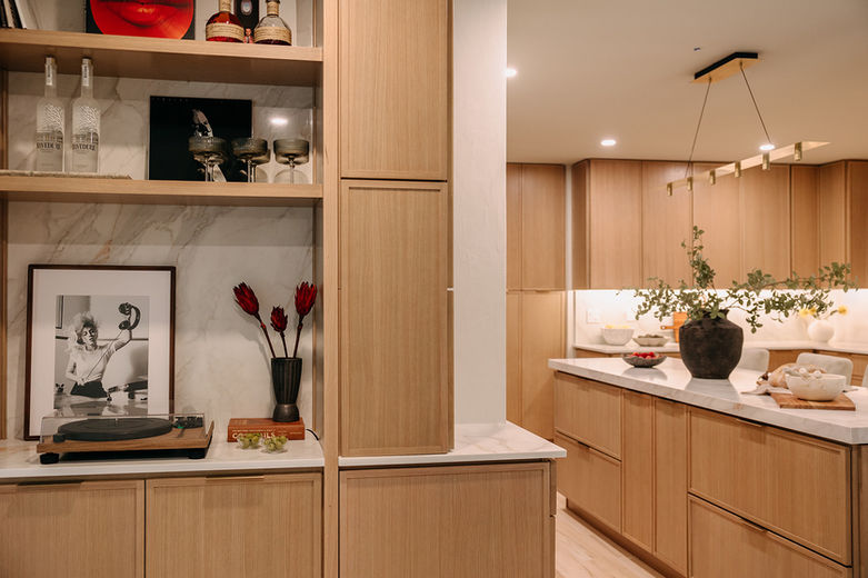 Light wood cabinets with marble-look quartz backsplash in Detroit home renovation