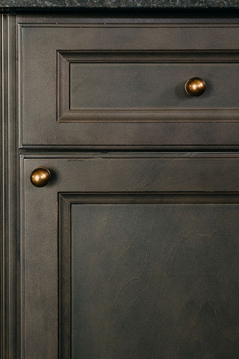Close-up of custom dark cabinetry with brass hardware. Metro Detroit custom kitchen remodel