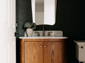 Vanity from right showing full mirror and pendant:
Powder room with globe pendant and walnut vanity — Oakland Township Michigan by Costello & Co Construction
