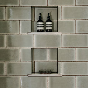 Built-in shower niche with sage zellige tile — Birmingham Michigan custom bathroom by Costello & Co Construction