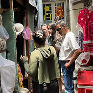 Tourists exploring narrow Saigon alley local market during authentic food tour in Vietnam street food discovery