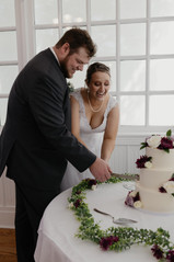 bride and groom cut the cake on their elopement day in eureka springs