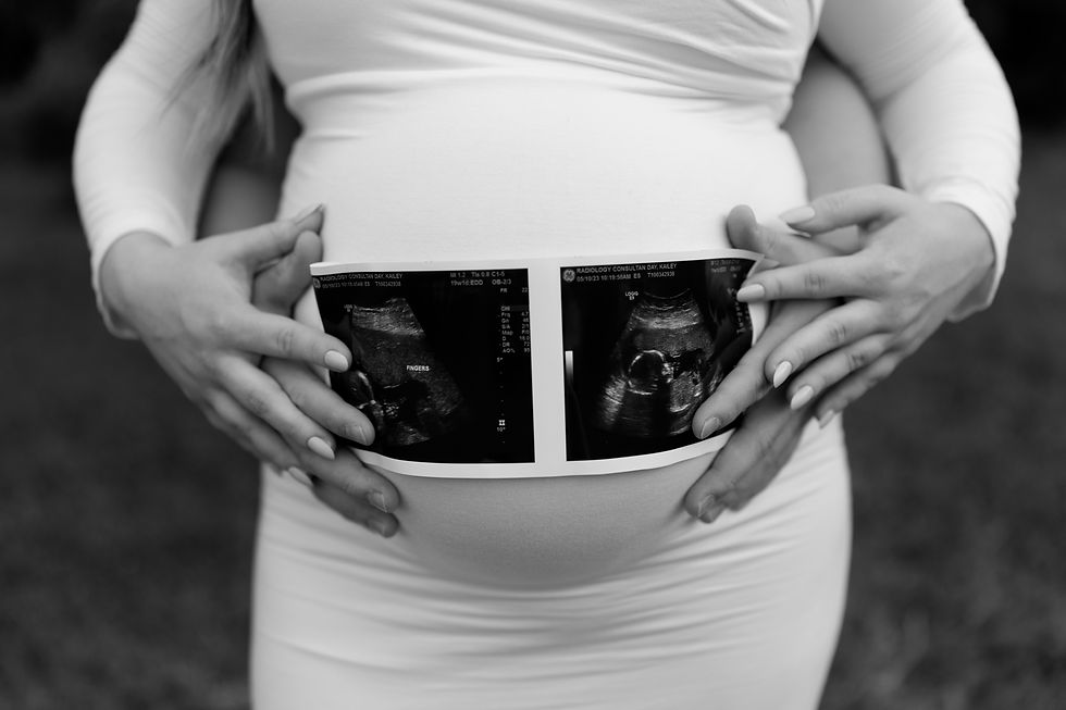 baby bump holding sonogram photo