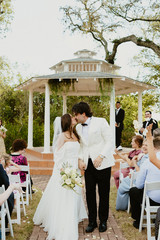 bride and groom kiss at the aisle