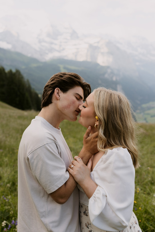 couple kissing in front of the Swiss alps in Switzerland