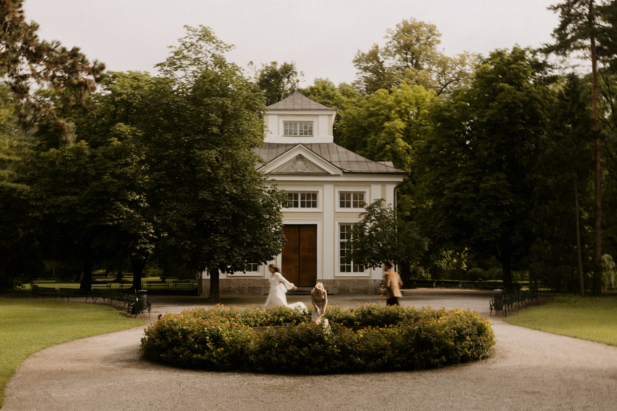couple playfully running together on their wedding day in front of wedding venue
