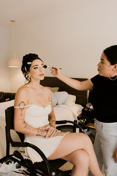 bride getting her makeup done on her wedding day in Palm Springs California