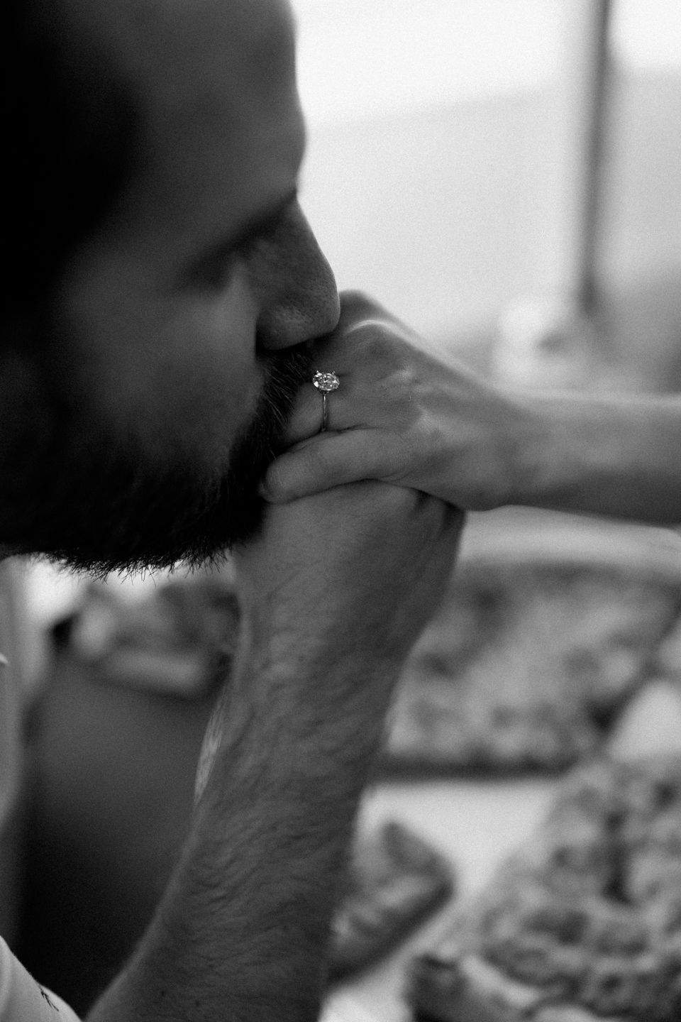 arkansas engagement photo groom kissing brides hand with engagement ring