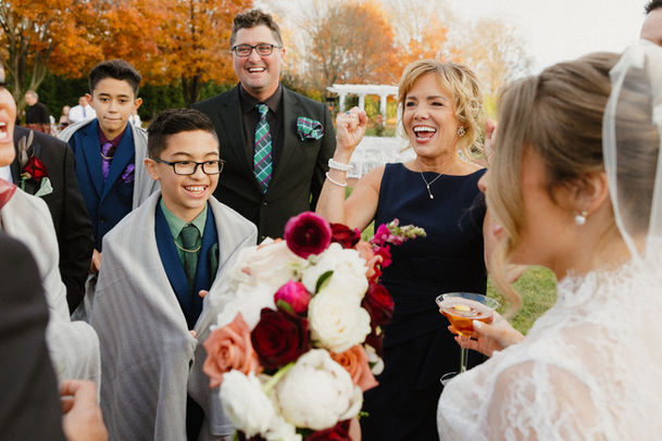 mother of bride cheering after the wedding