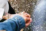 bride and groom hold hands while walking on Ruby Beach in Oregon