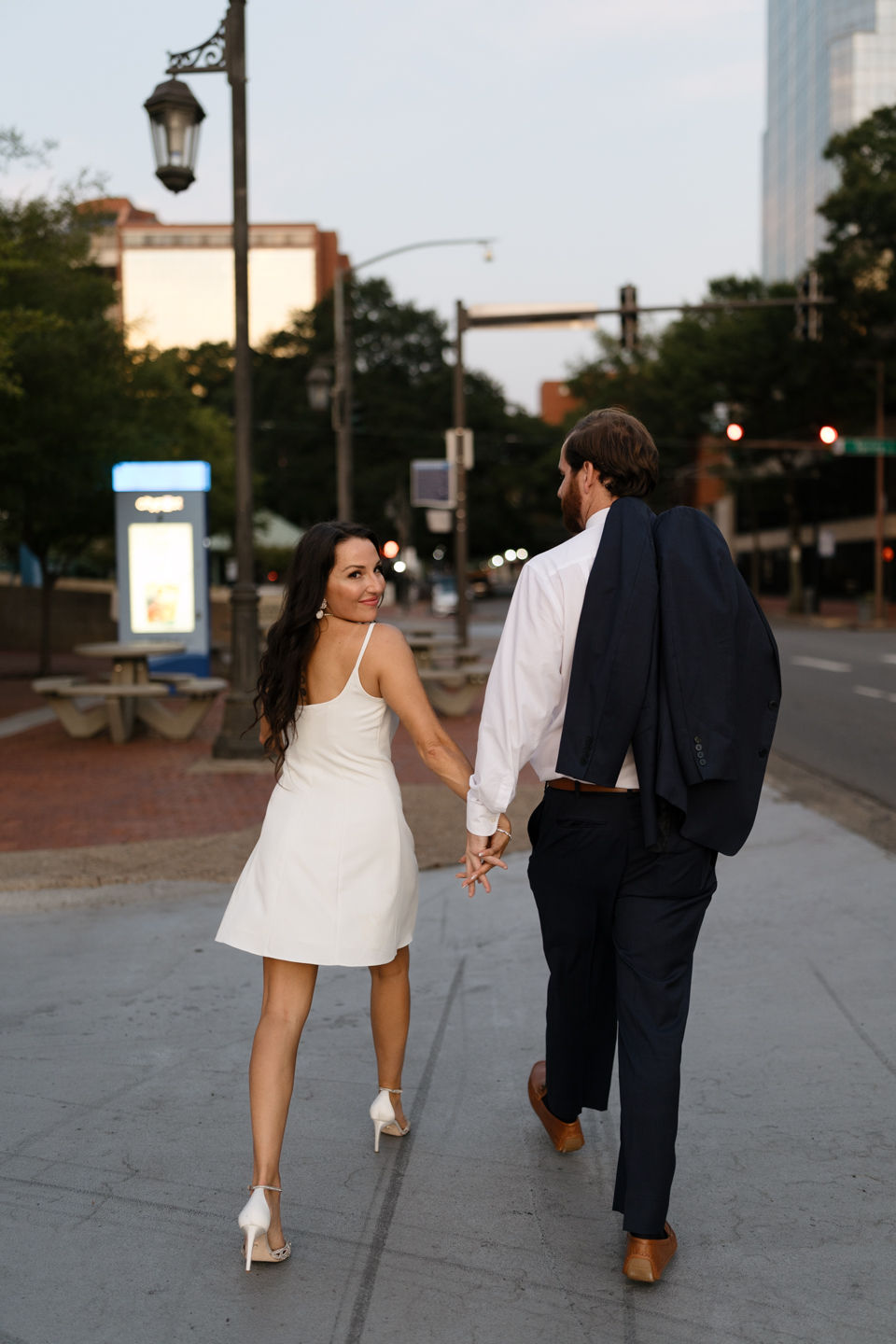 bride and groom walking in downtown Little Rock
