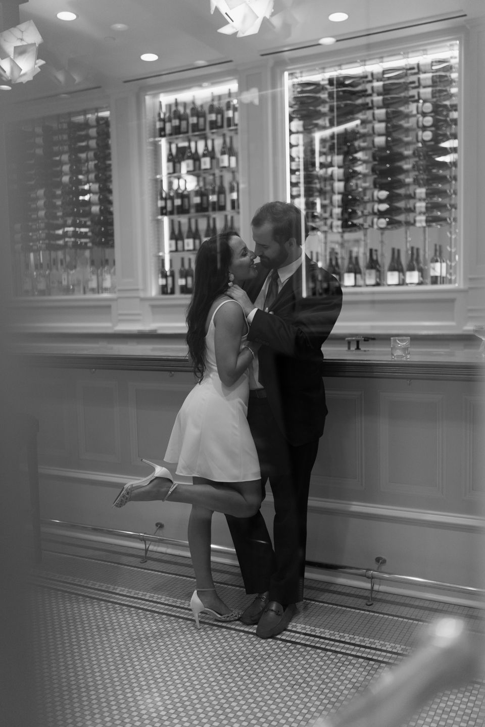 moody photo of bride and groom at bar