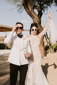 bride and groom with sunglasses on