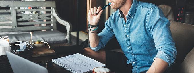 Young entrepreneur working on his project at street cafe