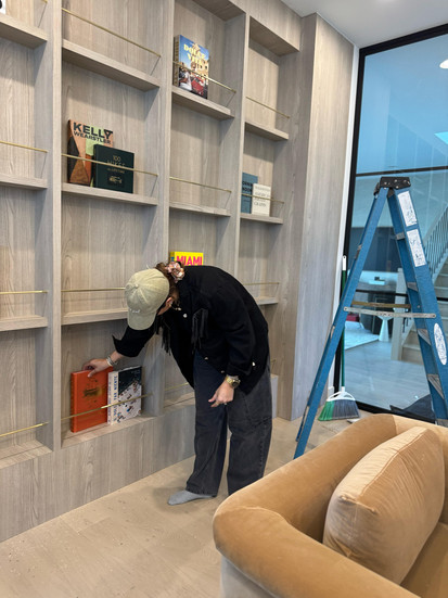 Woman styling shelves with books