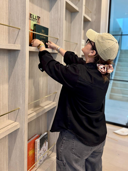 Woman styling shelves with books