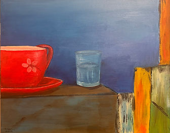 a brillant red cupof coffee with a glass of water