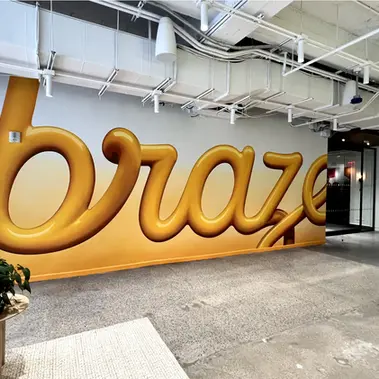 painted murals, custom fine art, wall art, corporate environment, Braze headquaters NYC. Through close collaboration with the Braze team, we facilitated the redesign of their new office space. Taking responsibility for the design, fabrication, and installation of all wayfinding elements, brand signage, and art walls, we ensured every detail aligned with Braze's vision. With a focus on meticulous craftsmanship, including custom fabrication and hand-painted murals, we created an immersive environment that authentically embodies Braze's identity.