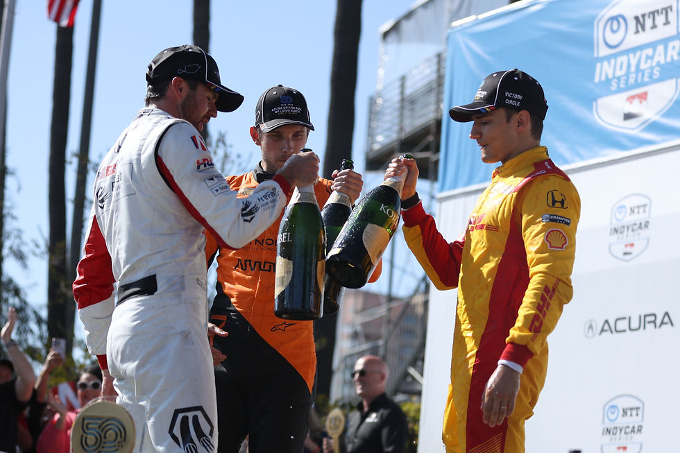 Alex Palou on the podium with Kyle Kirkwood and Christian Lundgaard