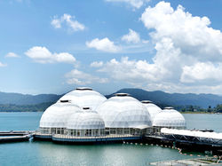 Front view of Malaysia’s largest floating dome complex at Kenyir Lake with clear skies