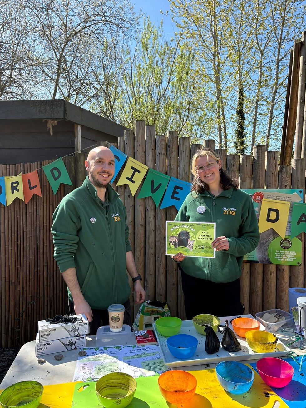 zoo keepers stand in front of world civet day banner
