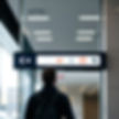 Person standing and looking at a sign with icons in a building.jpg