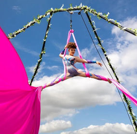 outdoor aerialist on pink silks
