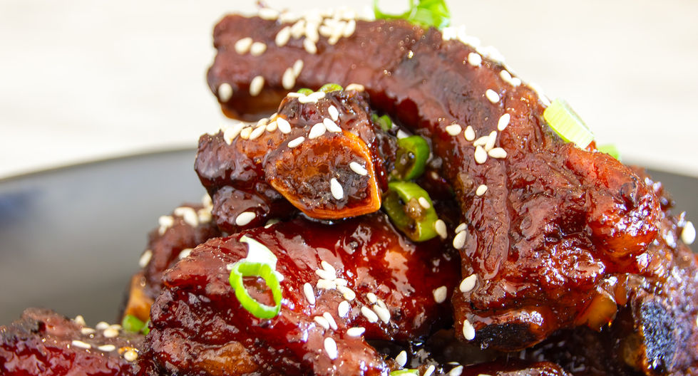 Stacked sticky ribs glazed with sweet soy sauce from Eleganté Cuisine catering menu