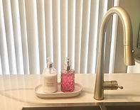 Gold kitchen tap and pink bottle_edited.jpg