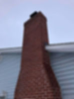 Tall chimney on the side of a house