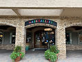 exterior sign of Nash Gallery along the arched brick wall