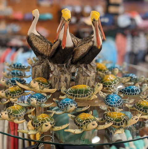 display shelf of porcelain Pelicans and turtles inside the gift shop