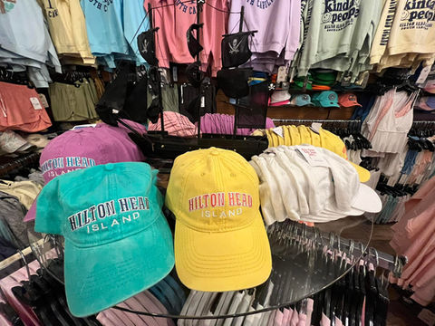 Hilton Head Island hats in bright colors on display inside the gift shop
