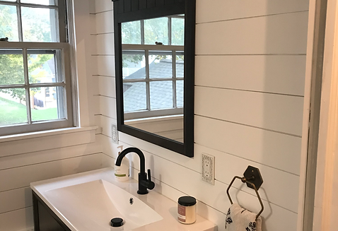 Modern bathroom remodel with shiplap walls, black fixtures, and new vanity installed by Oak & Co Property Services.