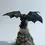 Thumbnail: Rear view of detailed black dragon statue with extended wings wrapped around a fantasy tower base