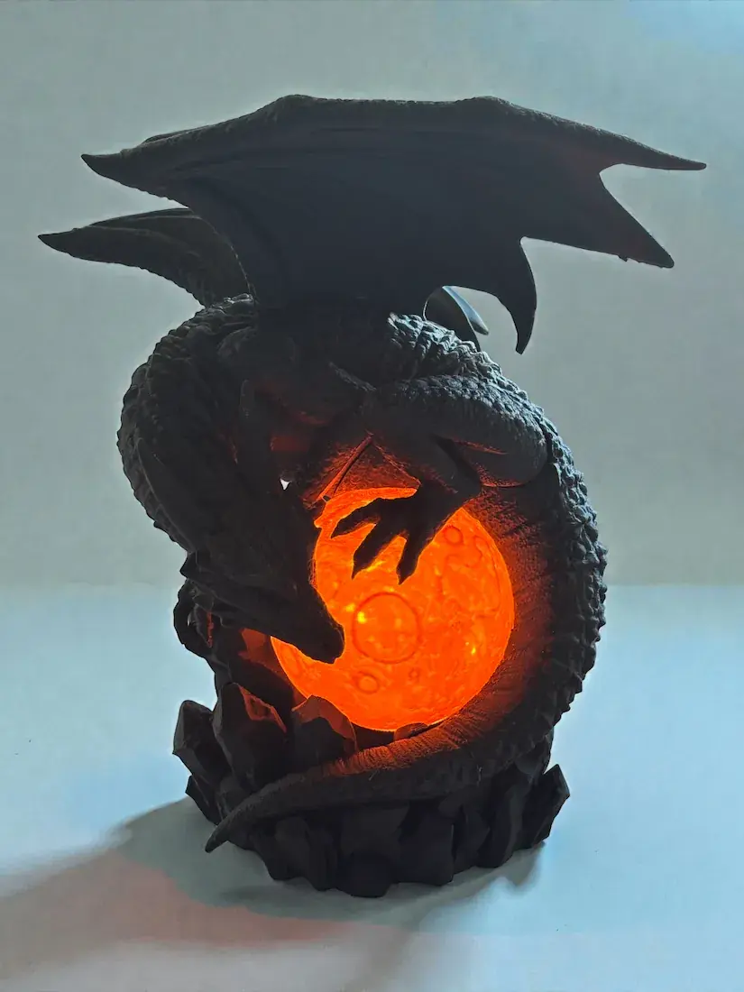Dragon Eclipse Lamp glowing with a fiery orange light inside the moon orb, illuminating the dragon’s silhouette.