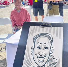Caricature Artist sketching a fun, personalized portrait of an employee and their family at a compnay party for the LA City Ports in Wilmington CA - unique entertainment for corporate events