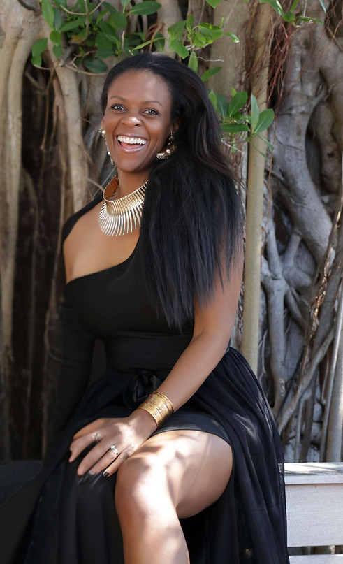 Dr. Simone Alicia, The Self Esteem Doctor, posing in gold and black during a professional brand photoshoot