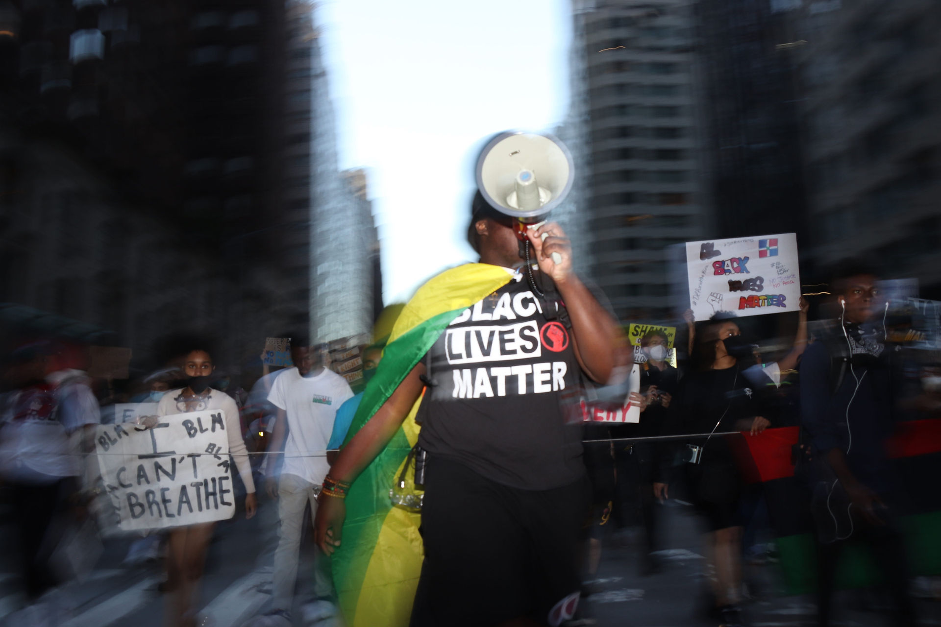 A man leads a protest through Midtown