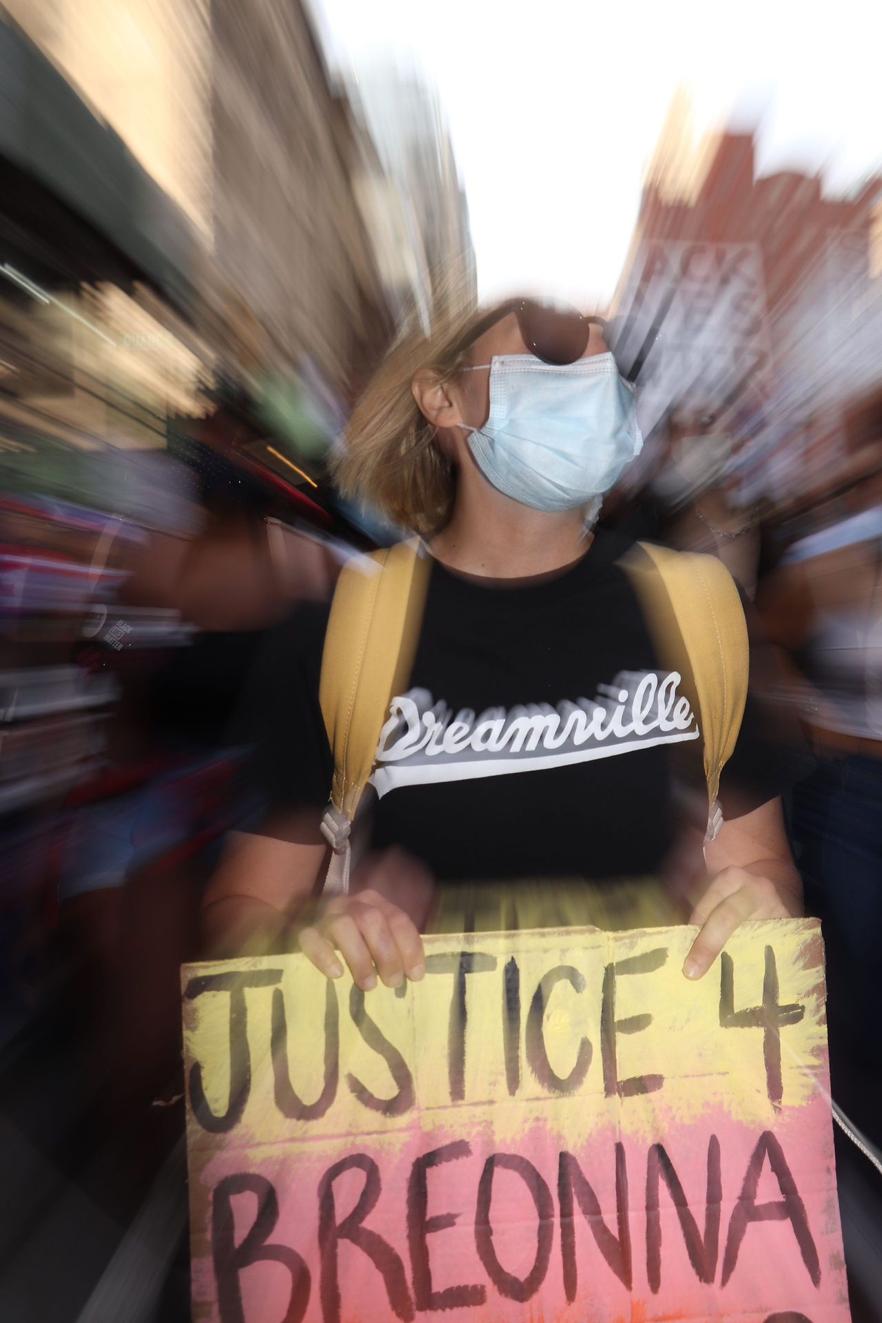 A woman marches through SoHo with a sign Reading Justice 4 Breonna Taylor