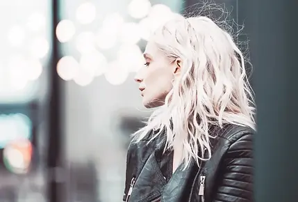 profile of a light-blonde woman wearing a leather jacket, staring into the distance. Second chance rockstar romance.