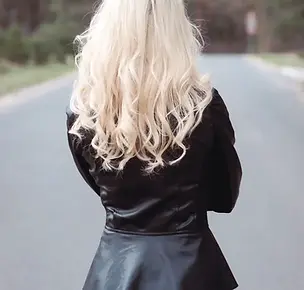 Light blonde woman wearing a leather jacket, facing away from the camera. Second chance rockstar romance.
