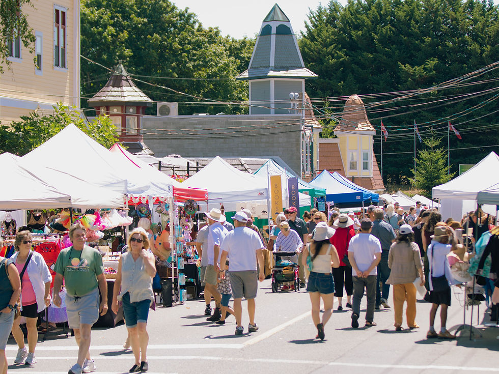 Crowds browse rows of vendor tents and outdoor displays during the Chemainus Giant Street Market in downtown Chemainus