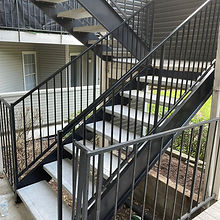 Code-compliant steel stairs with welded stringers and precast concrete treads for apartments.