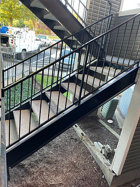 Code-compliant steel stairs with welded stringers and precast concrete treads for apartments.