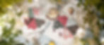 Two plates of cake on a patterned tablecloth outdoors, surrounded by colorful quilted fabric, forks, and plants; lemonade with citrus.