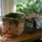 two fabric storage tubs on a kitchen windowsill